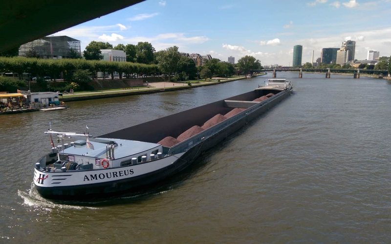 Transporting raw material on river Main, Frankfurt, Germany